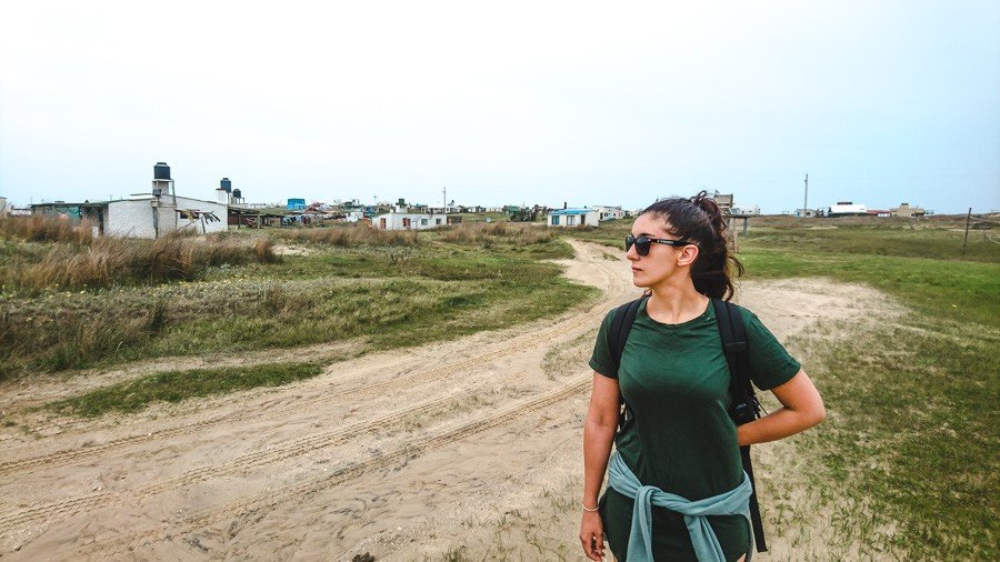 backpacker by the small cabin houses of cabo polonio uruguay