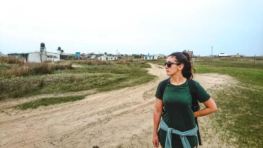 backpacker by the small cabin houses of cabo polonio uruguay