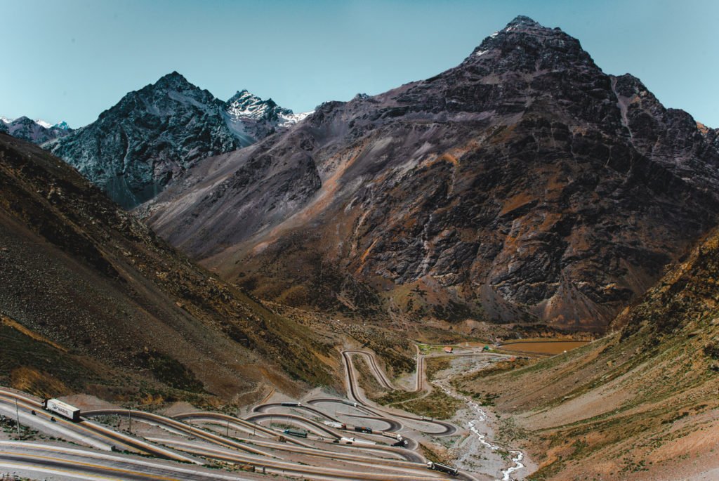 road to chile from argentina mendoza windy road bus route latin south america mountains andes path journey travel trip blog guide santiago