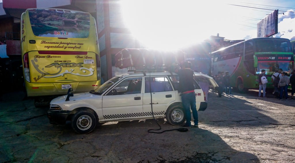 Coffin being loaded onto night bus in Bolivia | How to get to Sucre bus terminal travel guide