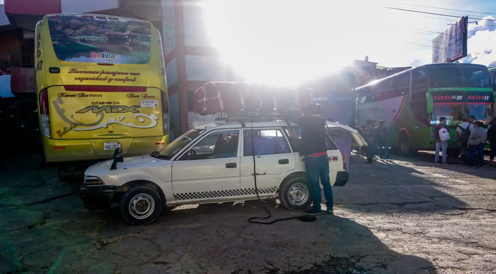 Coffin being loaded onto night bus in Bolivia | How to get to Sucre bus terminal travel guide