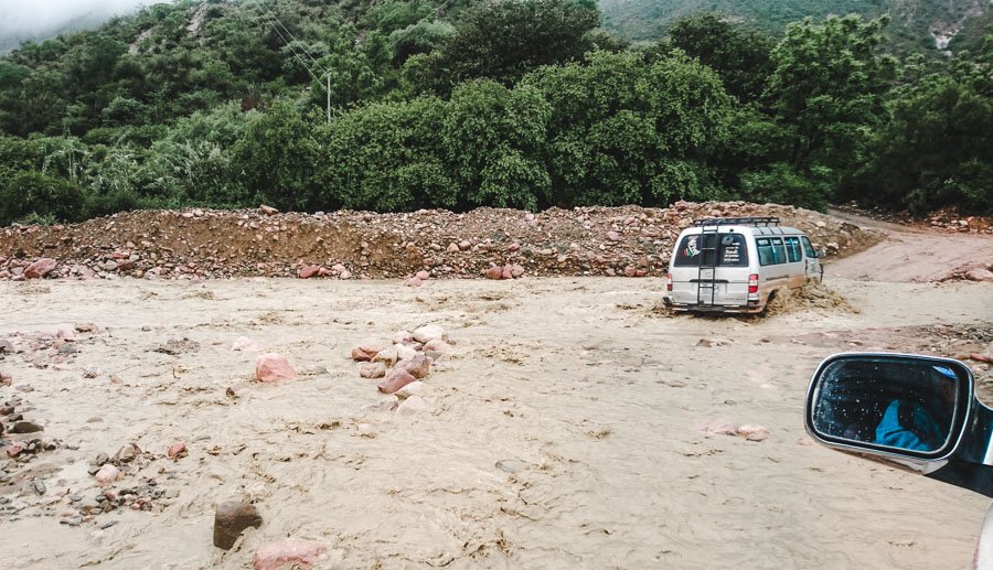 tours in torotoro bolivia: driving through river
