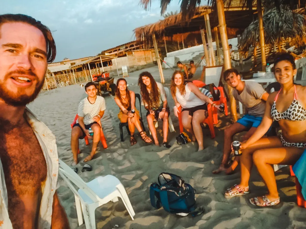 travellers on beach of mancora peru