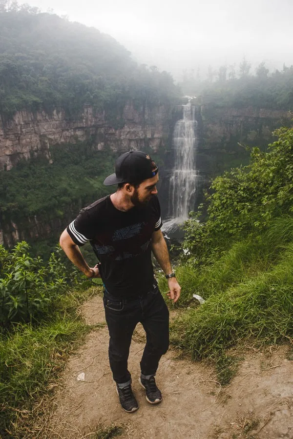 backpacker in front of salto del tequendama on a day trip from bogota colombia