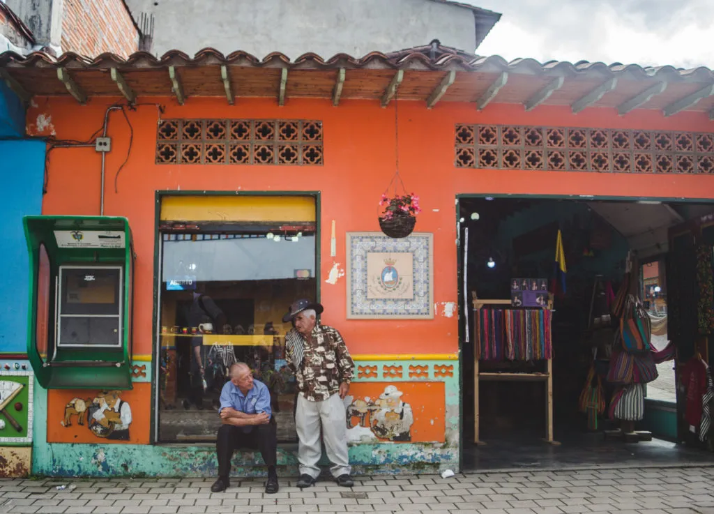 Old men in Guatapé - best places for your first time in Latin America if you don’t speak Spanish