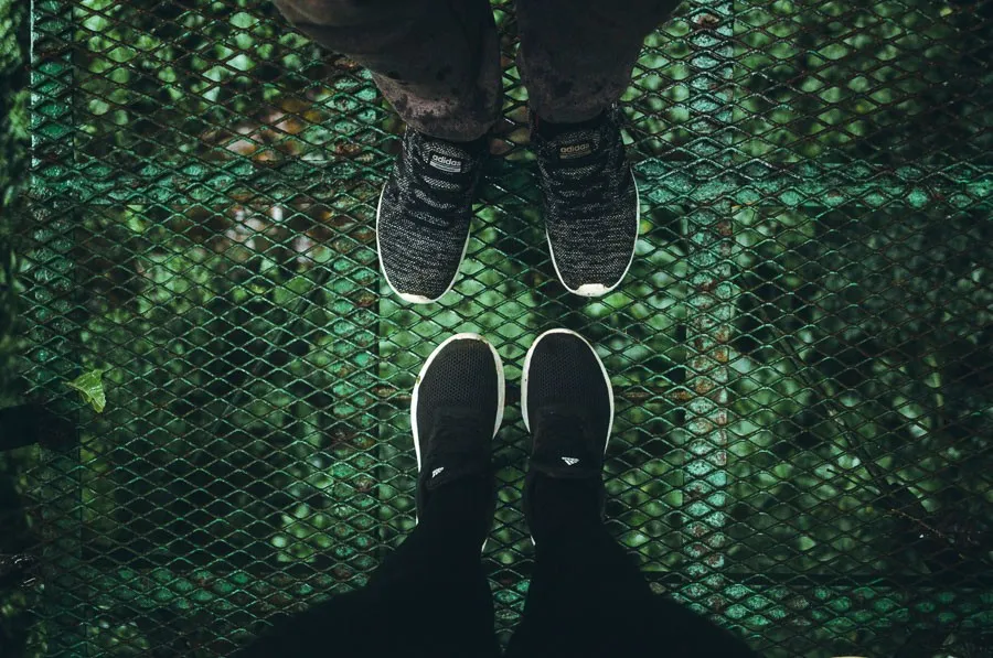 looking down at feet on mistico hanging bridges - famous landmarks in costa rica