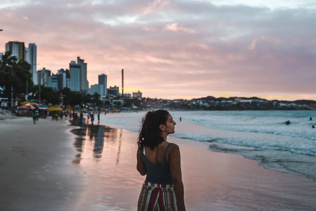 backpacker girl on beach in brazil at sunset: why it's great for having travel on your résumé